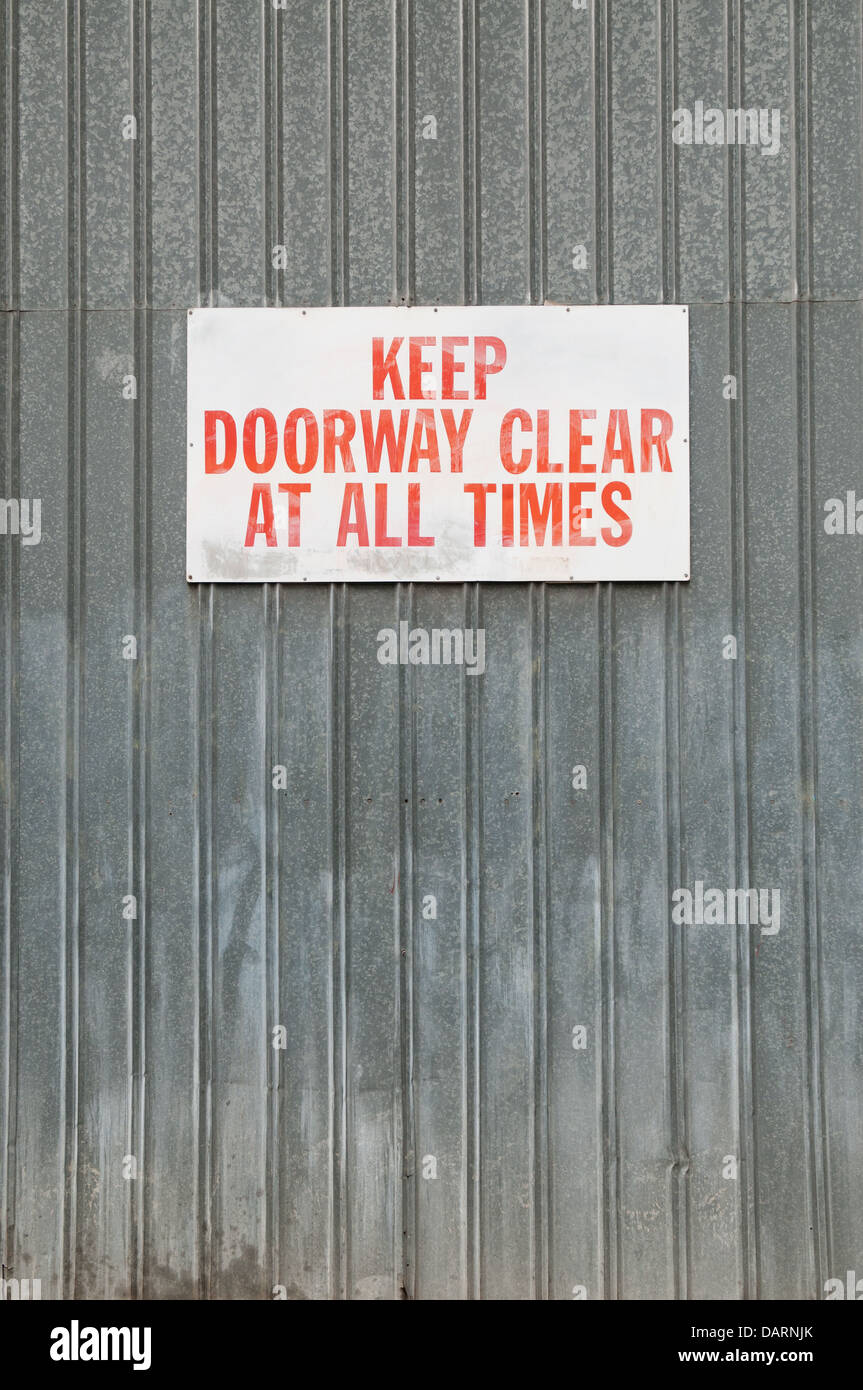 Garder une porte signe clair monté sur un mur de métal Banque D'Images