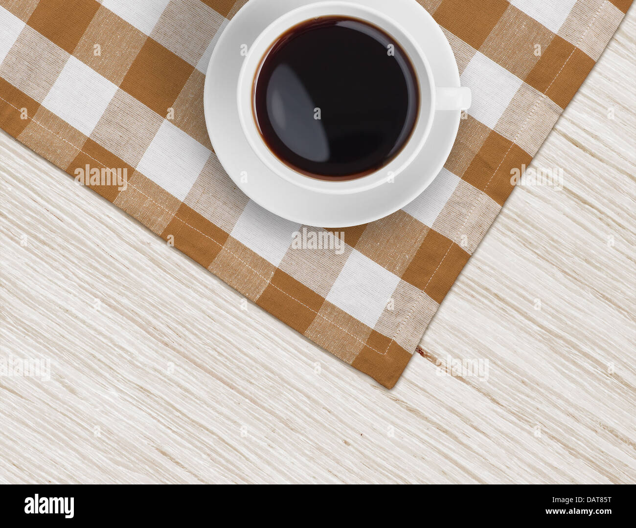 Vue de dessus la tasse de café sur la nappe sur une table en bois Banque D'Images