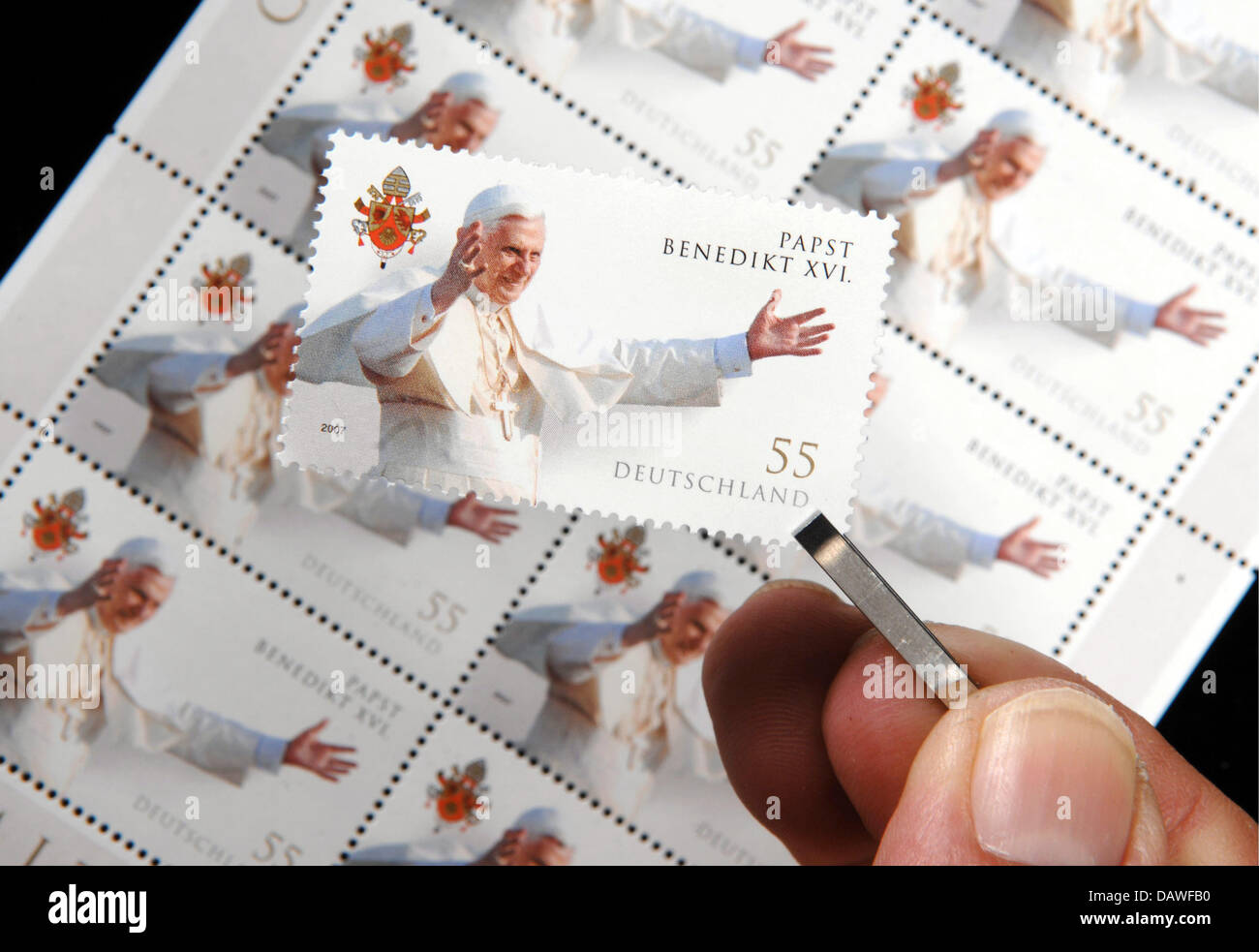 La photo montre une main tenant un timbres spéciaux avec l'image du Pape Benoît XVI avec des brucelles à Straubing, en Allemagne, le jeudi 12 avril 2007. La Poste allemande a commencé à offrir l'estampillage pour 55 cent quatre jours seulement avant le Pape Benoît XVI célèbre son 80e anniversaire lundi prochain, le 16 avril. En raison de la forte demande attendue la Poste allemande a produit plus de 10 mil Banque D'Images