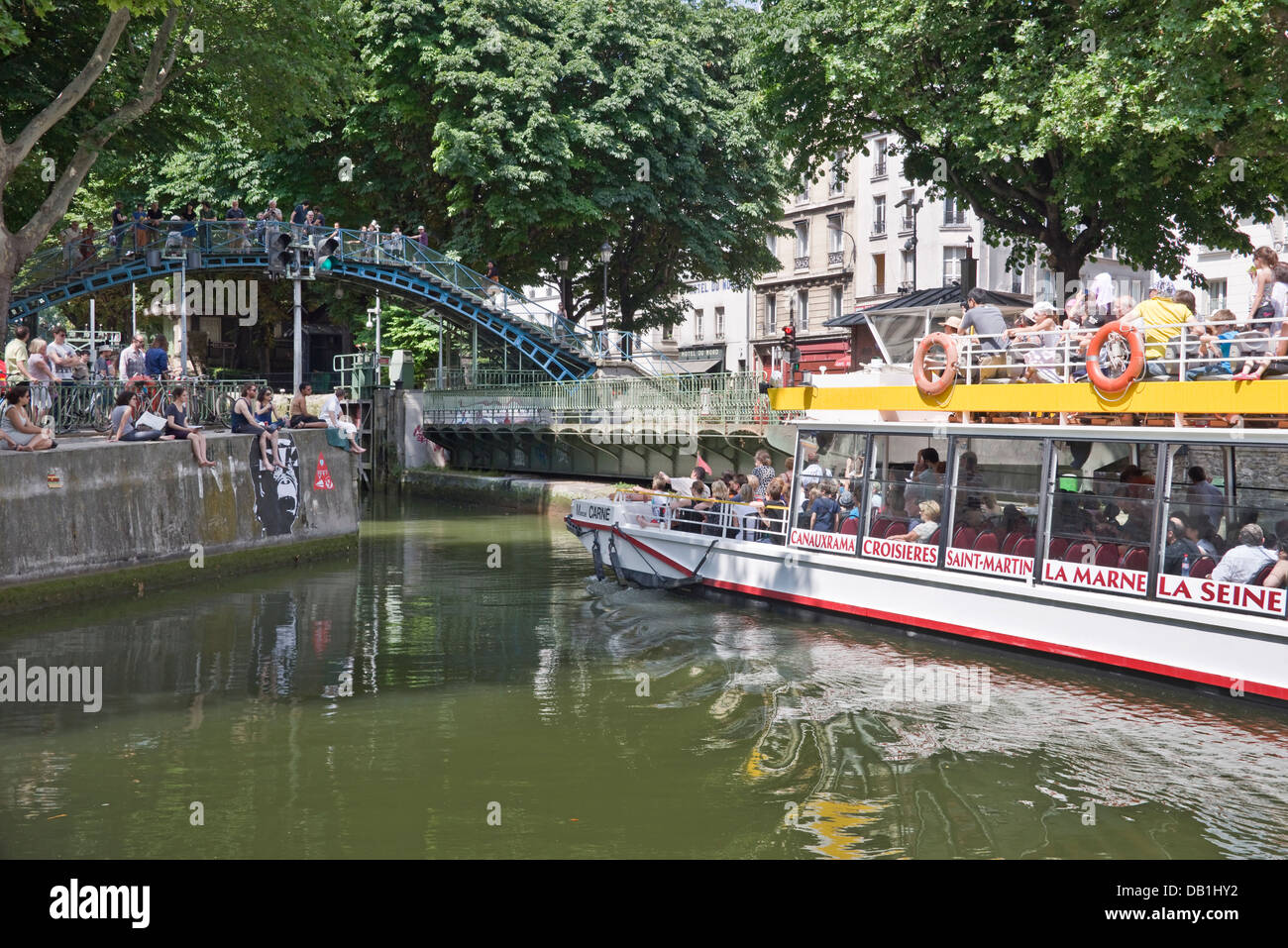 L'ouverture du pont tournant pour un bateau de croisière touristique sur le canal St-Martin, près de l'hôtel du nord - Paris, France Banque D'Images
