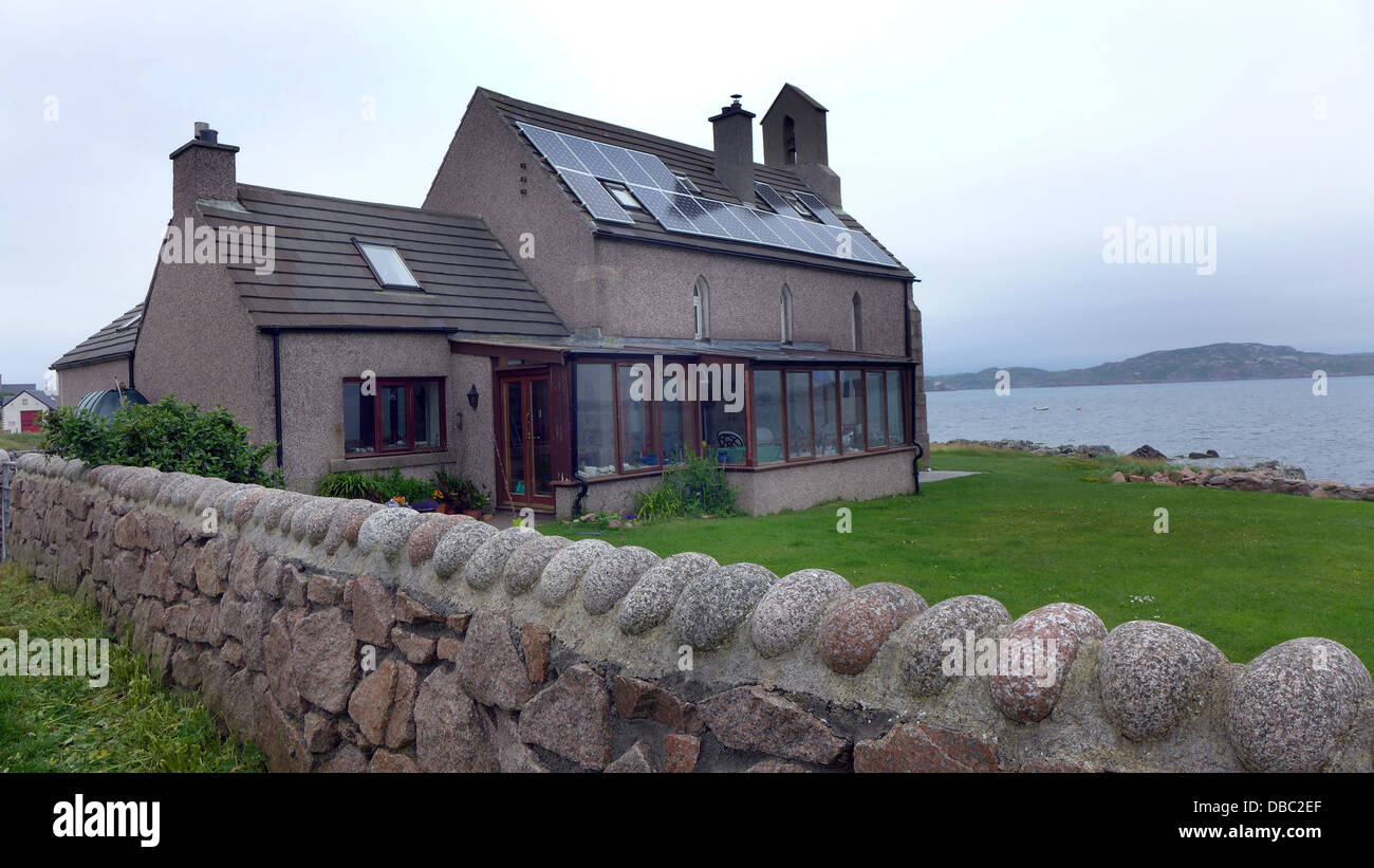 Des panneaux solaires sur une maison convertie à partir d'une chapelle donnant sur le son d'Iona Banque D'Images