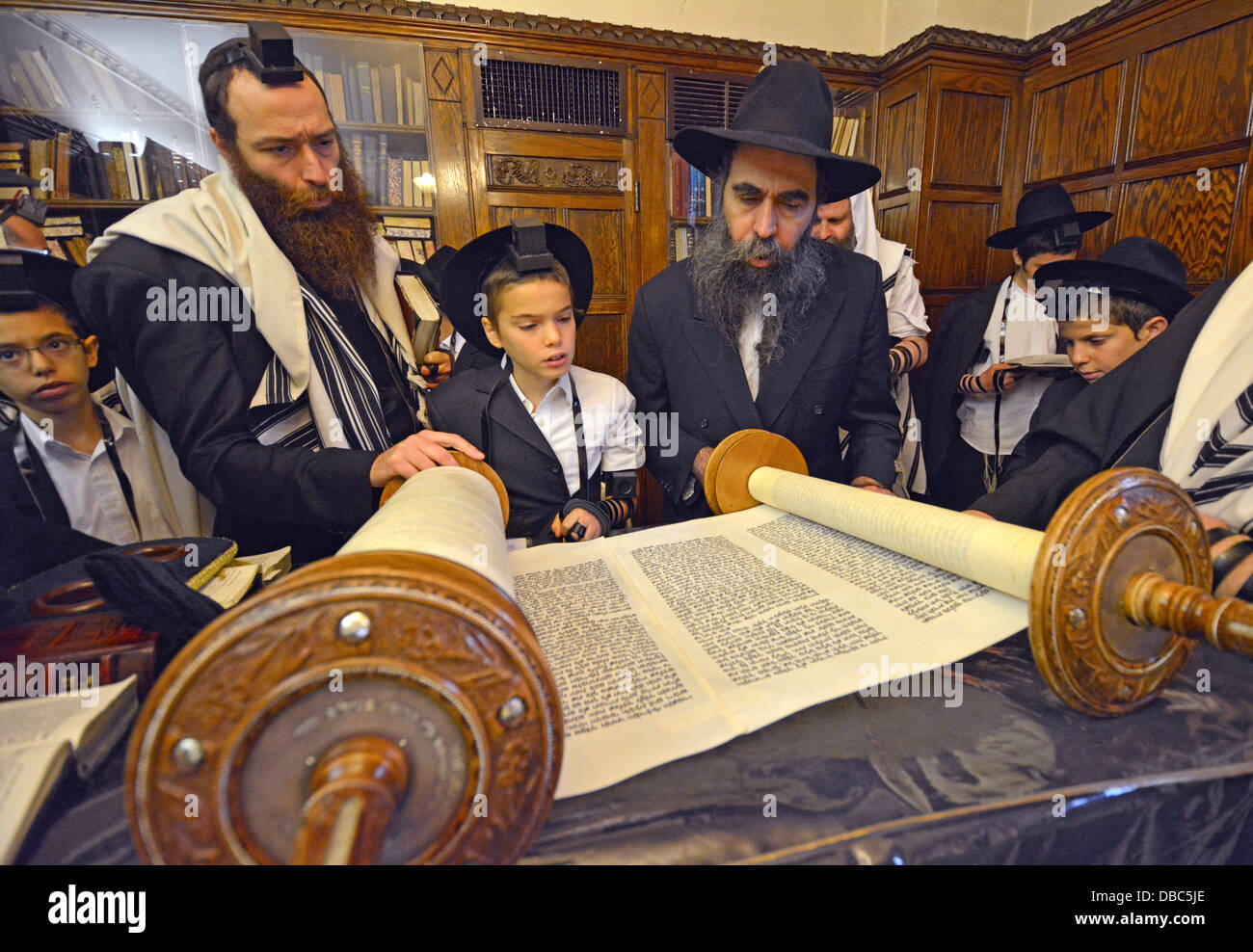 Les juifs religieux prient dans l'étude du Rebbe de Loubavitch siège à Brooklyn, New York. Bar Mitzvah garçon appelé à la Torah. Banque D'Images