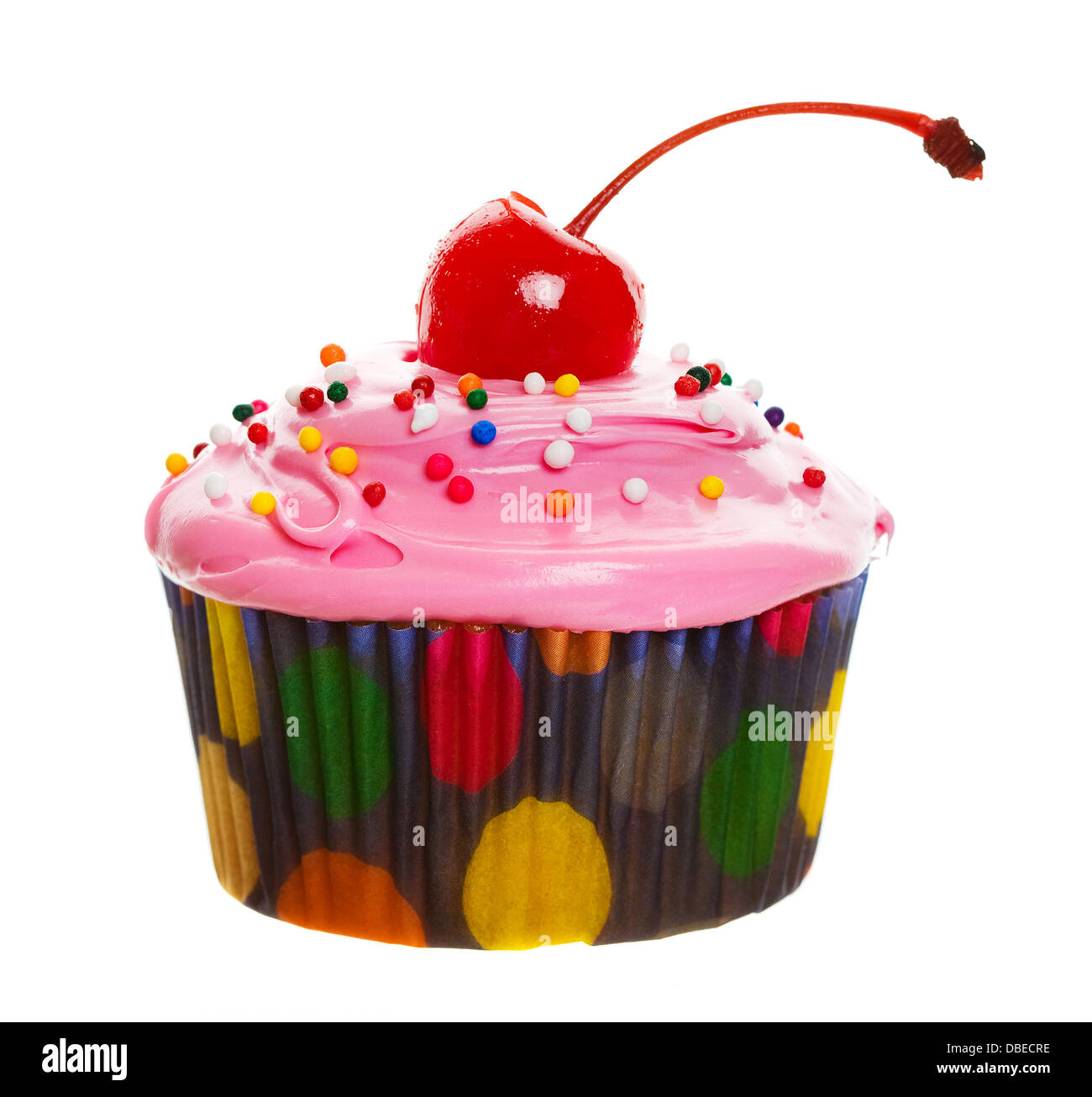 Un petit gâteau coloré avec une cerise sur le dessus Banque D'Images