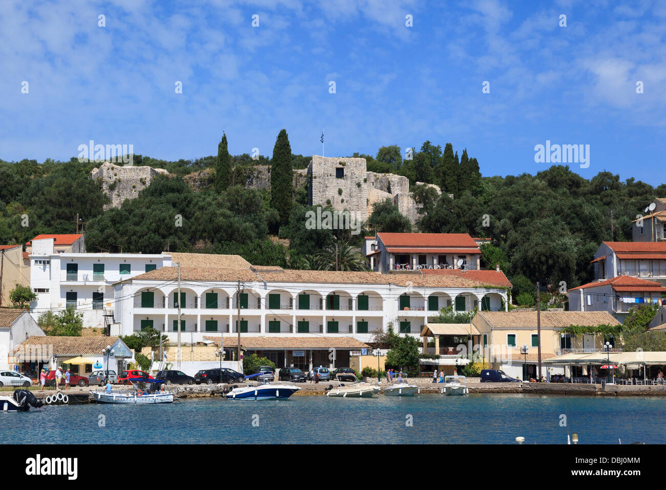 Seaside apartments à Kassiopi avec l'ancien château sur la colline derrière Banque D'Images
