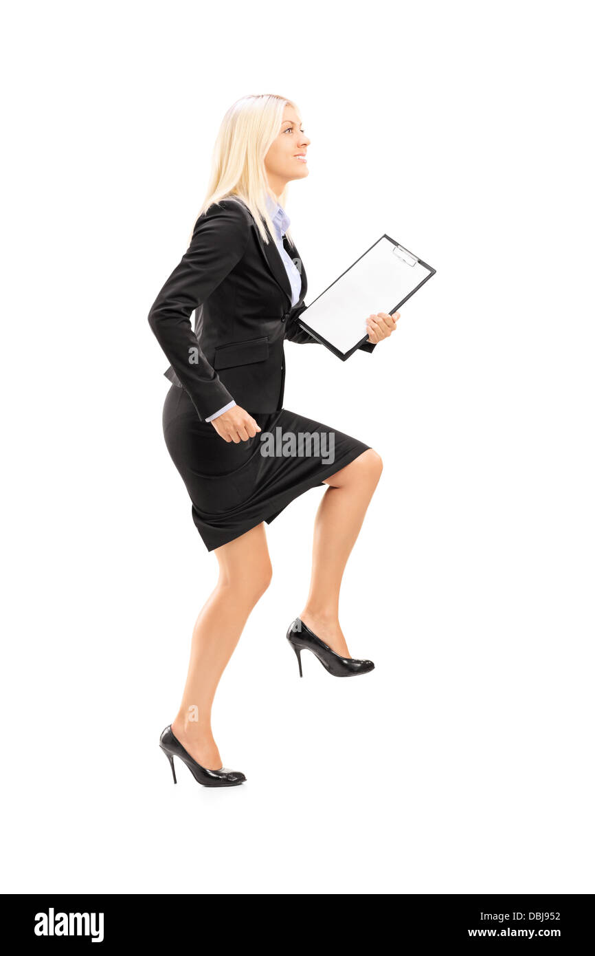 Full Length portrait of a young businesswoman faire un énorme pas vers isolé sur fond blanc Banque D'Images