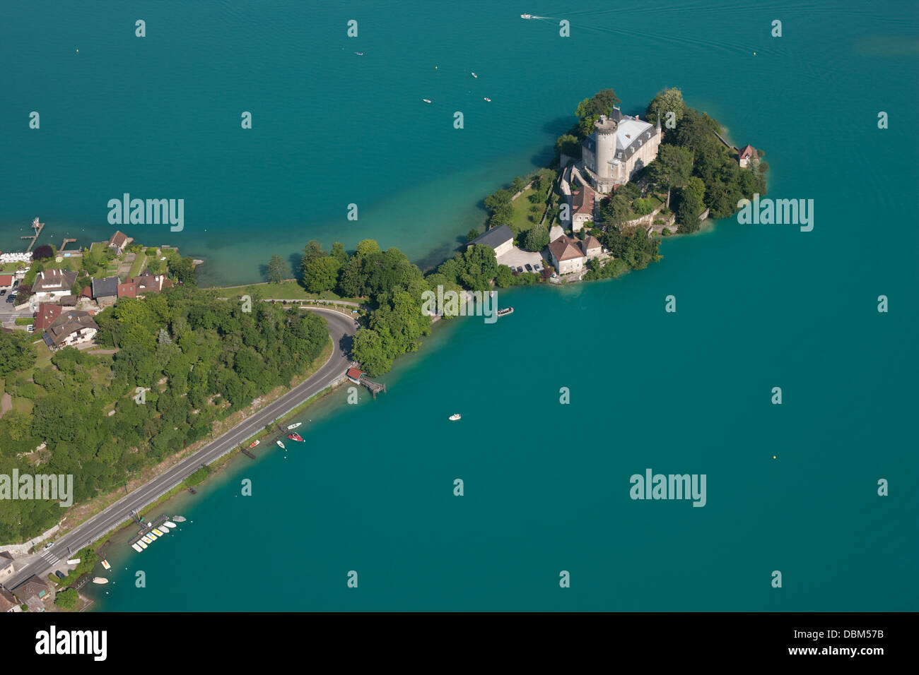 VUE AÉRIENNE.Château médiéval sur une péninsule dans les eaux turquoises du lac d'Annecy.Château de Duingt, haute-Savoie, France. Banque D'Images