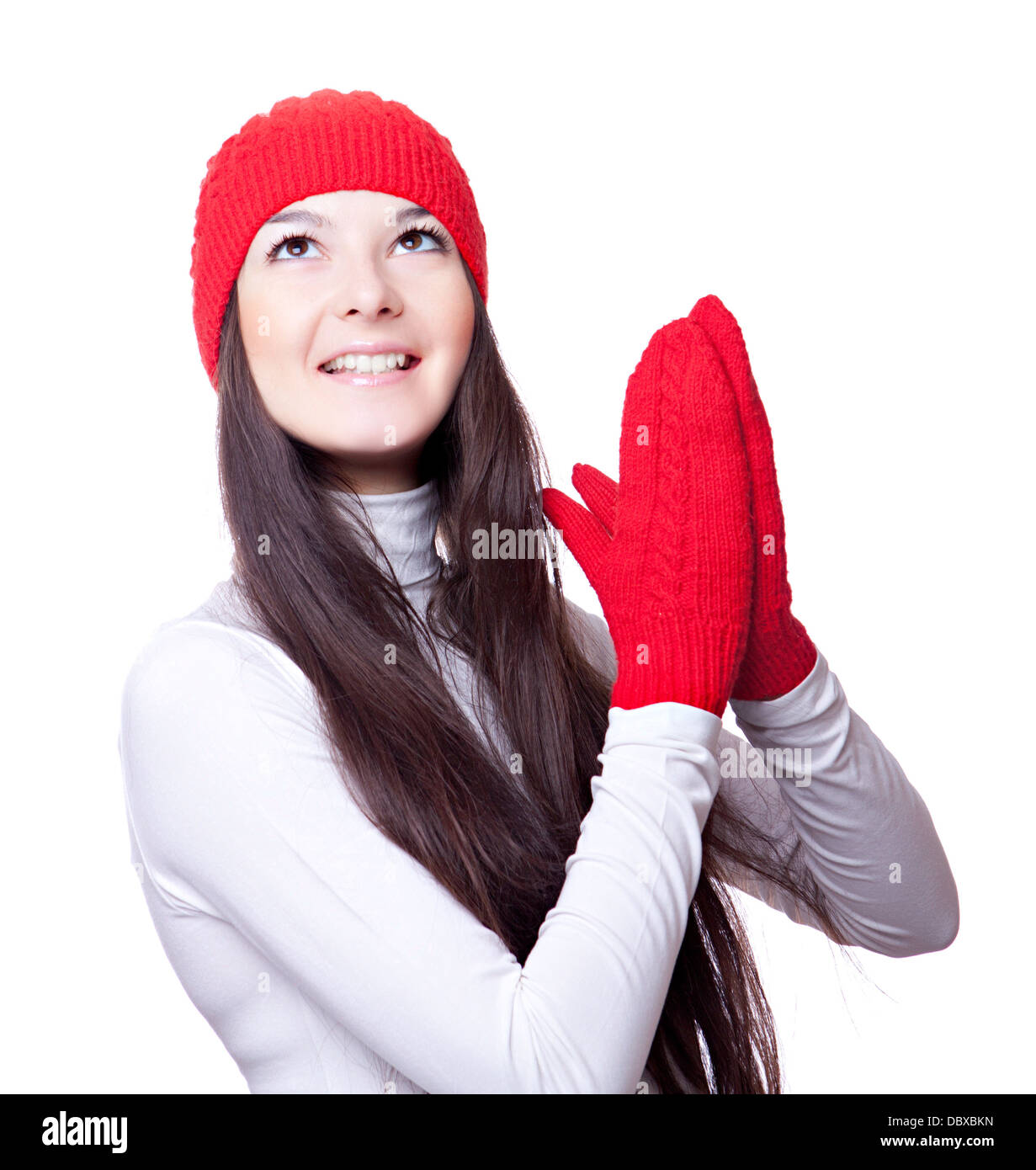 Femme en bonnet rouge et mitaines se réjouit Banque D'Images