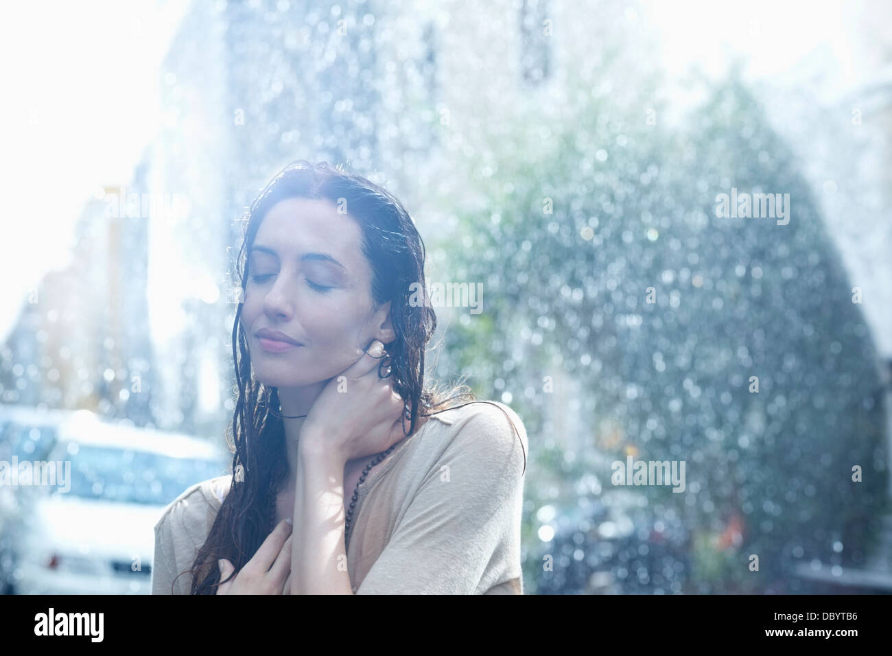 Serene woman standing in rain Banque D'Images