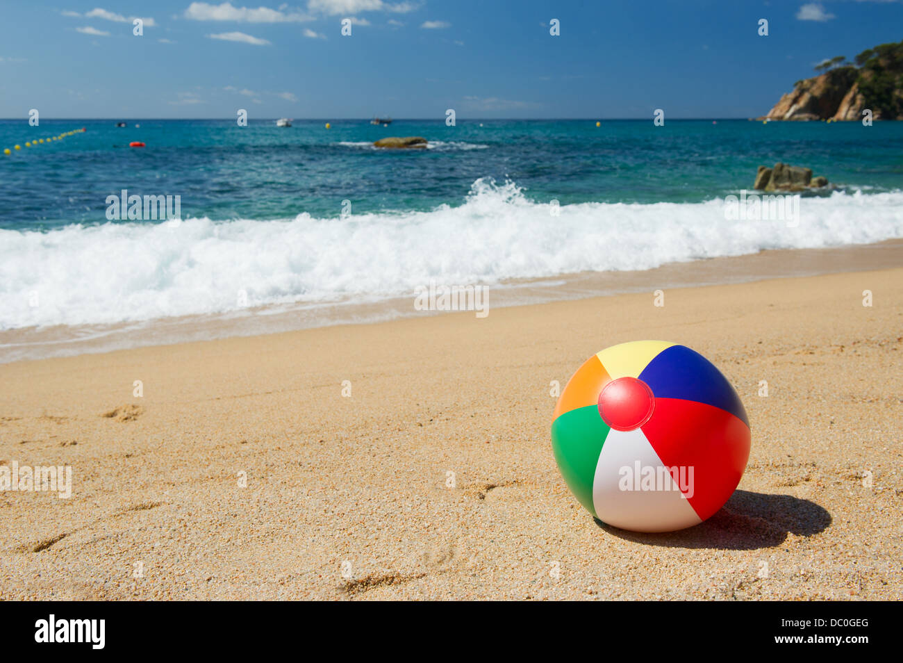 Ballon de plage gonflable dans le sable près de la ligne d'eau à la plage d'Espagnol Banque D'Images