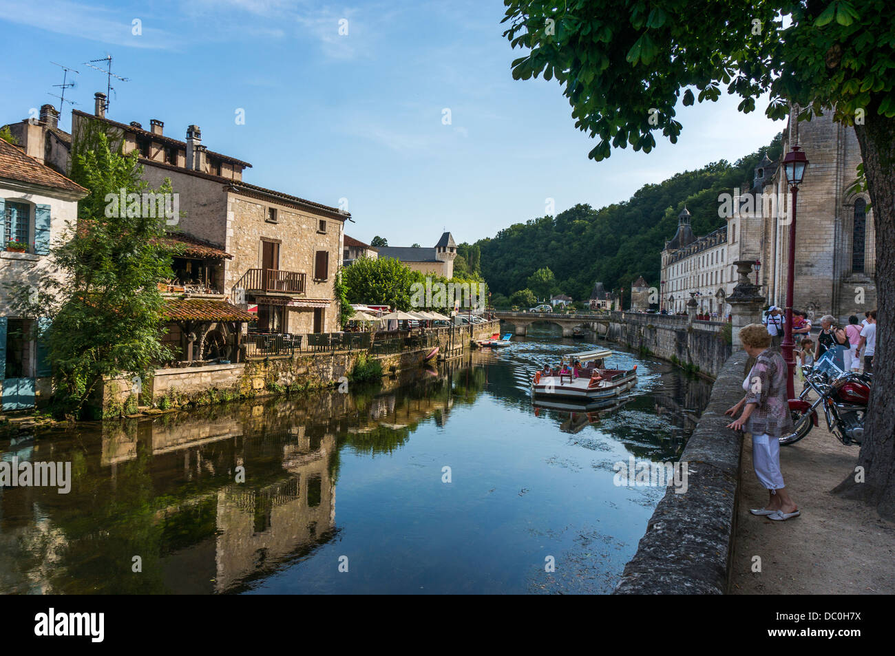 Dronne, avec une note de bateau d'excursion et de l'abbaye et les gens en gardant à l'ombre, à Brantôme, en Dordogne dans le sud-ouest de la France, l'Europe. Banque D'Images