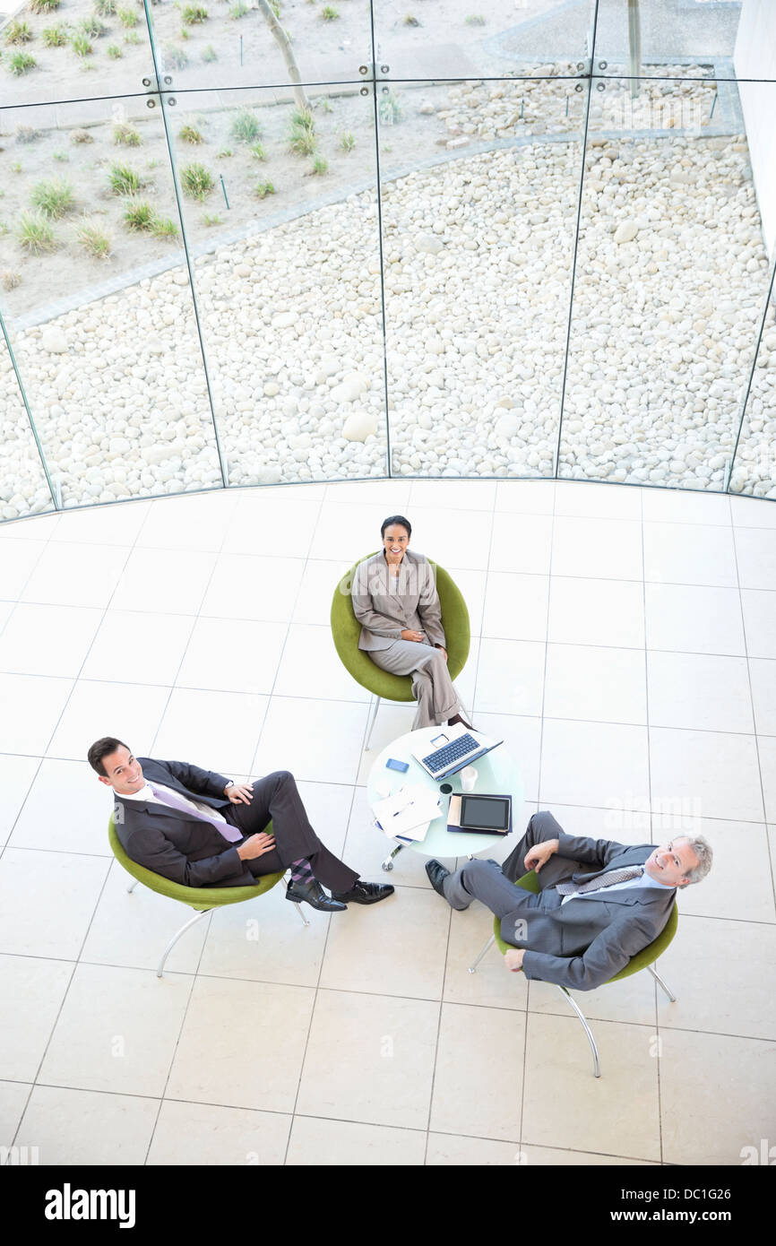 High angle portrait of business people in lobby Banque D'Images