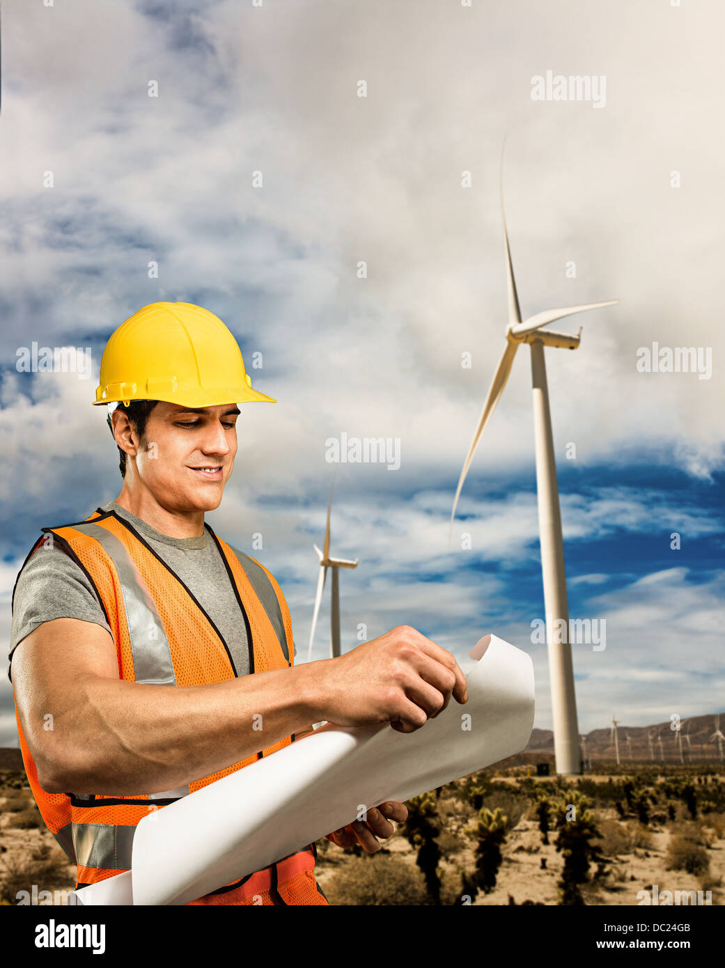 Man standing in front of wind farm Banque D'Images