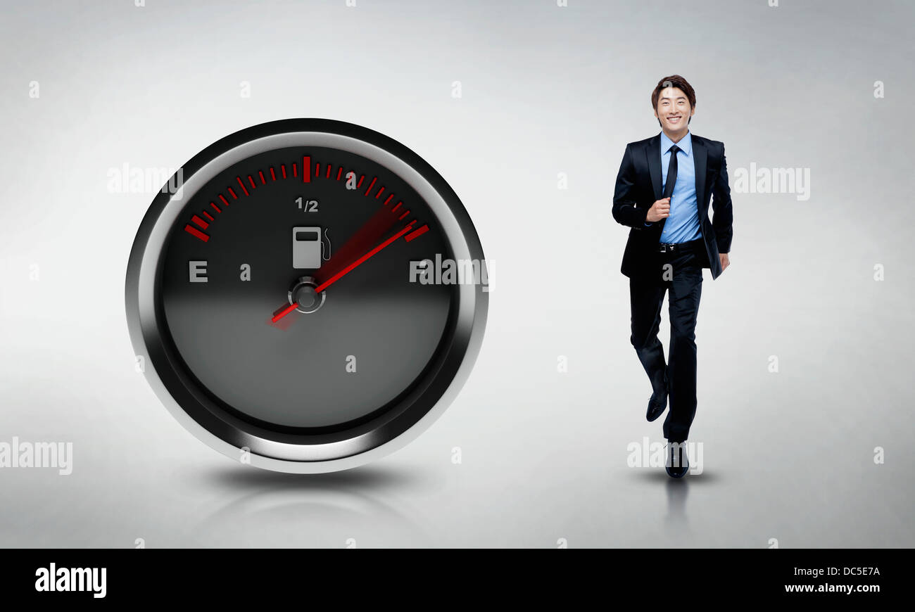 Illustration d'un homme qui court à côté d'une jauge de carburant Banque D'Images