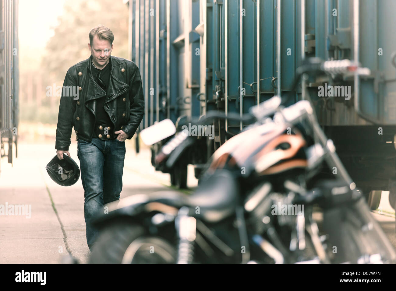 Jeune homme portant des vêtements en cuir avec sa Harley Davidson Photo  Stock - Alamy