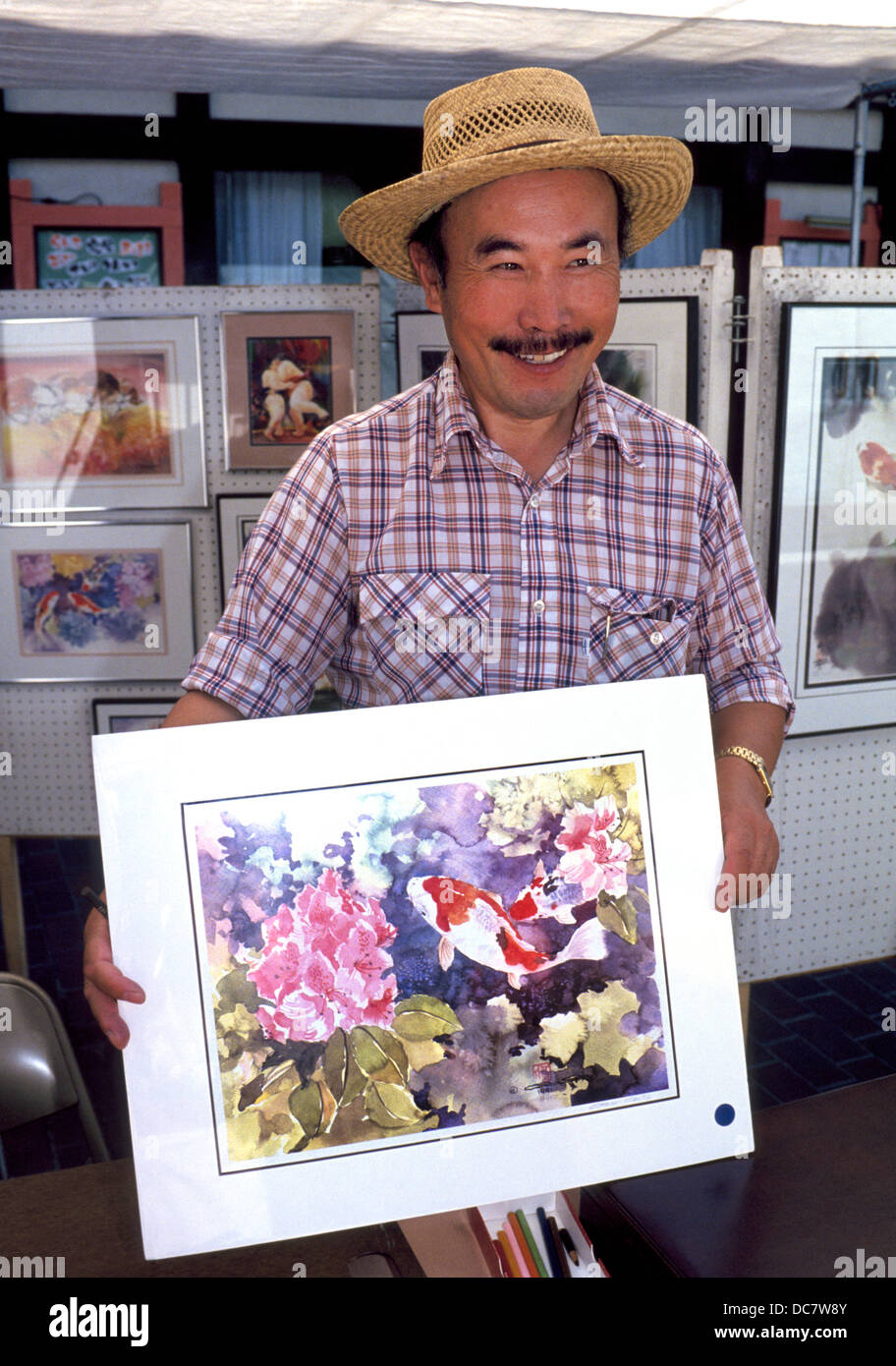 Un artiste montre son aquarelles dans ce petit stand de trottoir de Tokyo en Japonais Village Plaza dans le centre-ville de Los Angeles, Californie, USA. Banque D'Images