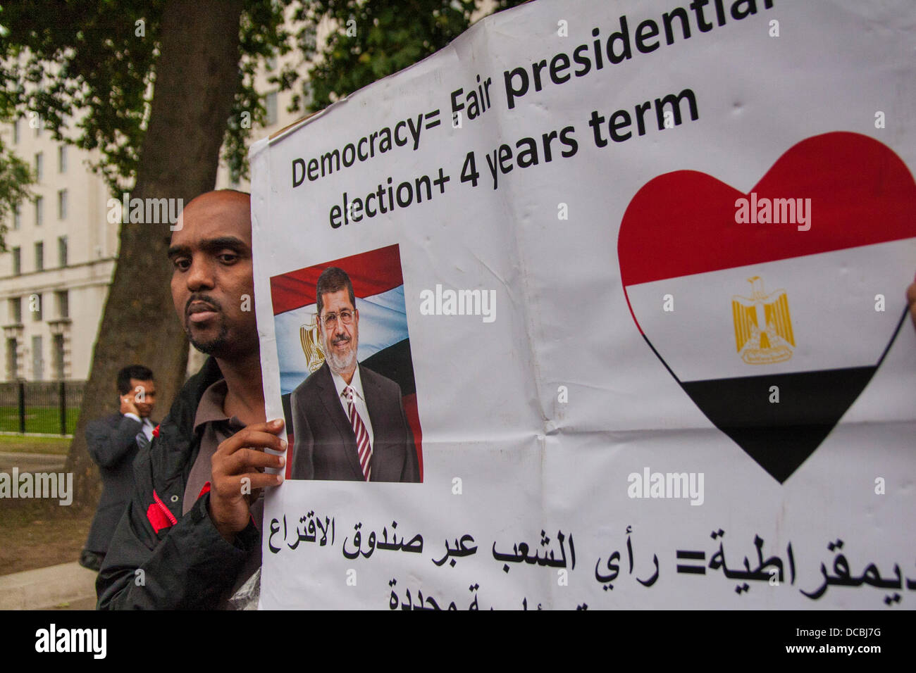 Londres, 08-14-2013, un militant pro-Morsi avec sa bannière comme égyptiens manifestation devant Downing Street à la suite de ce qu'ils disent a été massacres de partisans des Frères Musulmans, laissant 'plus de 2 000 morts, comme des camps de protestation à travers le pays ont été visés par l'armée. Crédit : Paul Davey/Alamy Live News Banque D'Images