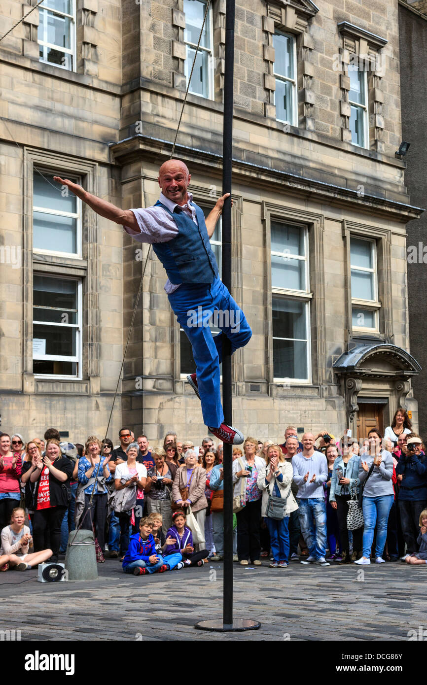 Acrobat performing un équilibre sur un poteau, Royal Mile, Edinburgh Fringe Festival, Édimbourg, Écosse, Royaume-Uni Banque D'Images