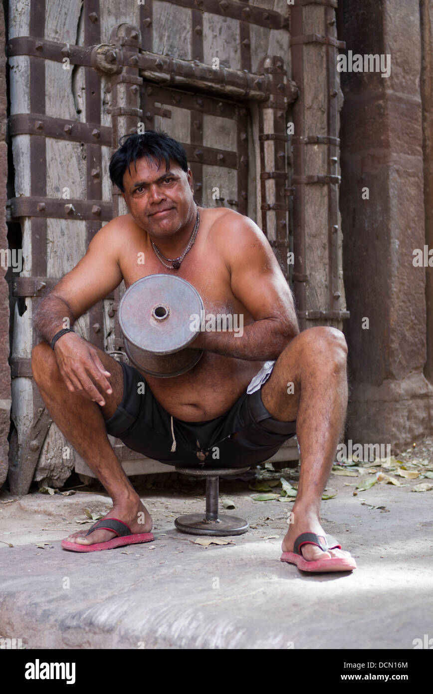L'homme indien avec formation à l'extérieur des portes de dumbells Meherangarh Fort - Jodhpur, Rajashtan, Inde Banque D'Images