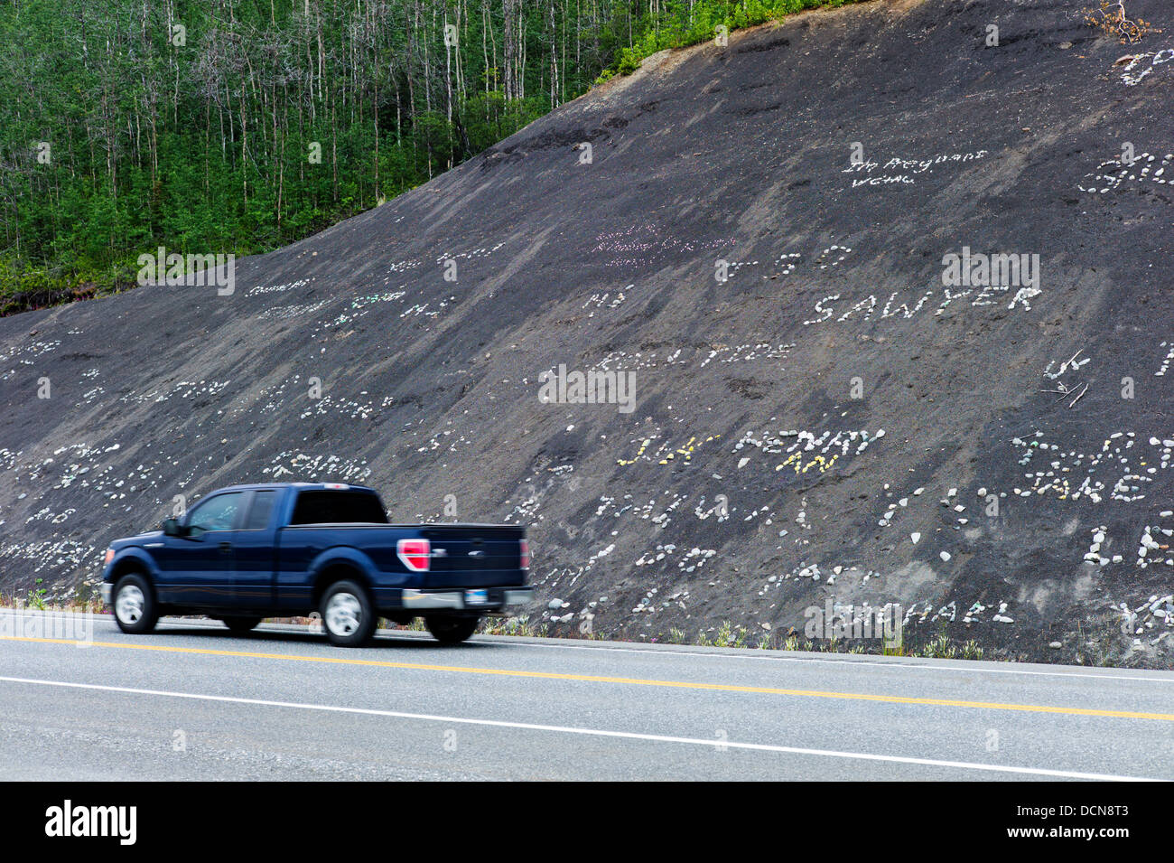 Les enfants utilisent des roches blanches sur la colline noire pour créer des signes et nom, Glenn Highway, la Route 1, de l'Alaska Banque D'Images