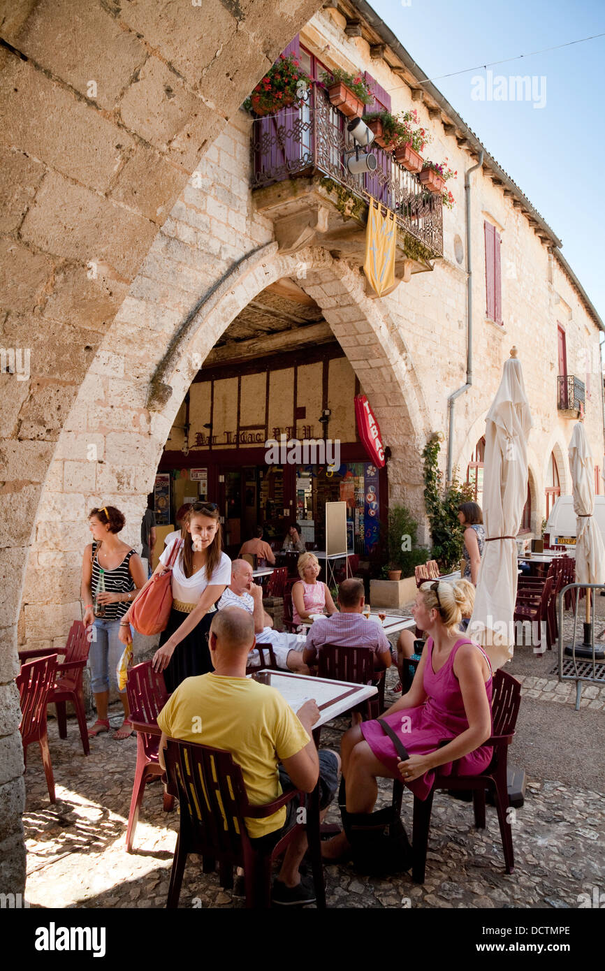 Les personnes mangeant à l'extérieur dans un café, la bastide médiévale de Monpazier, Dordogne, France Europe Banque D'Images