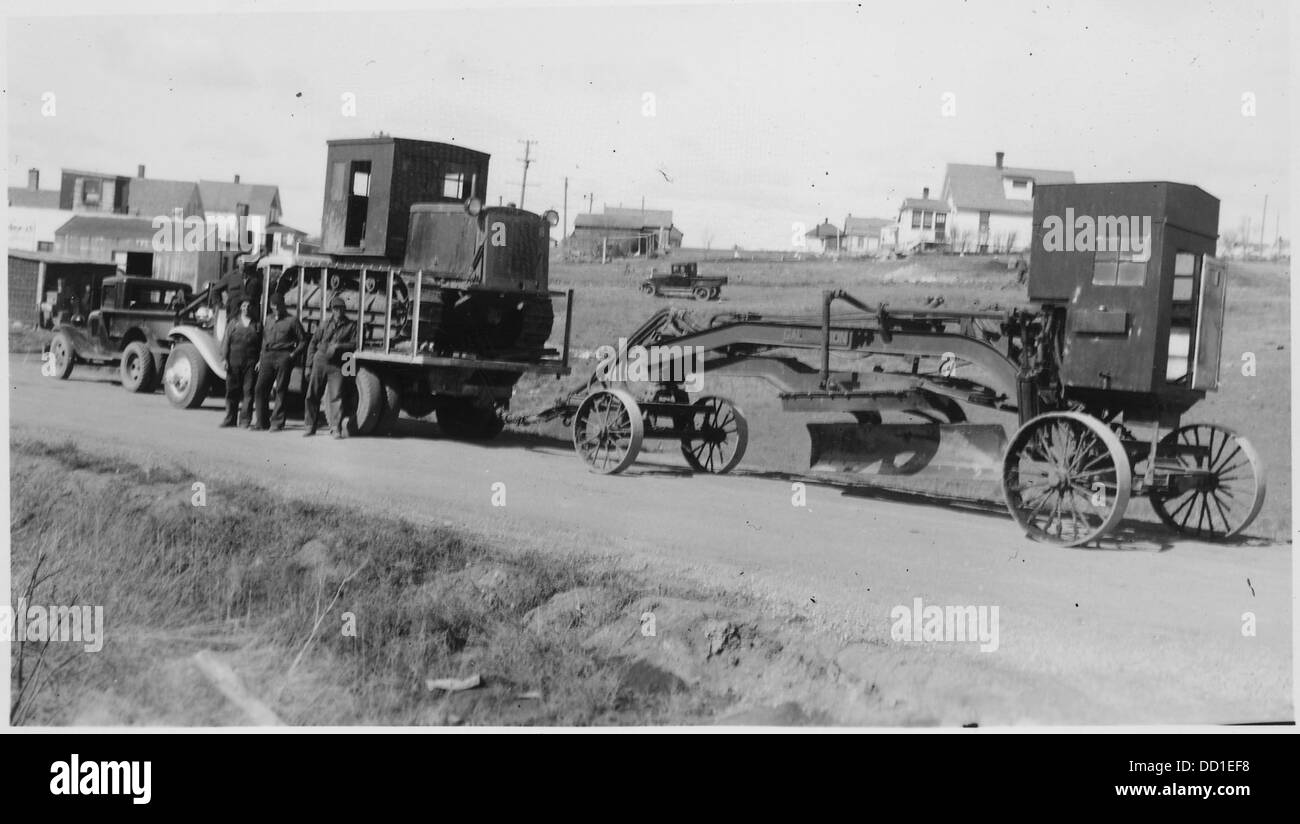 Photographie d'une ancienne niveleuse et d'autres équipements de construction, montrant les machines utilisées dans la construction de routes et les projets d'infrastructure dans le passé. Banque D'Images
