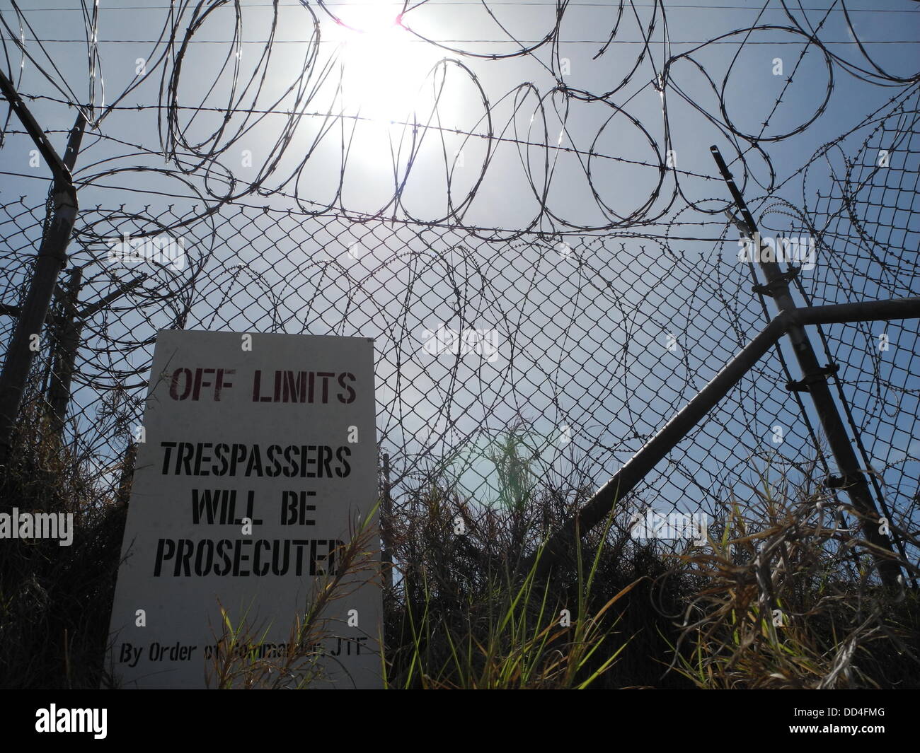 Une entrée interdite signer se bloque sur une clôture de la prison fermée camp 'Camp X-Ray" dans la baie de Guantanamo, Cuba, 22 août 2013. Il y a encore des choses en cours à l'camp de détention de Guantanamo Bay qui doit rester derrière des portes fermées. Mais alors que les hommes sont encore dans les chaînes, la terreur a depuis longtemps fait place à la routine. Photo : Johannes Schmitt-Tegge Banque D'Images