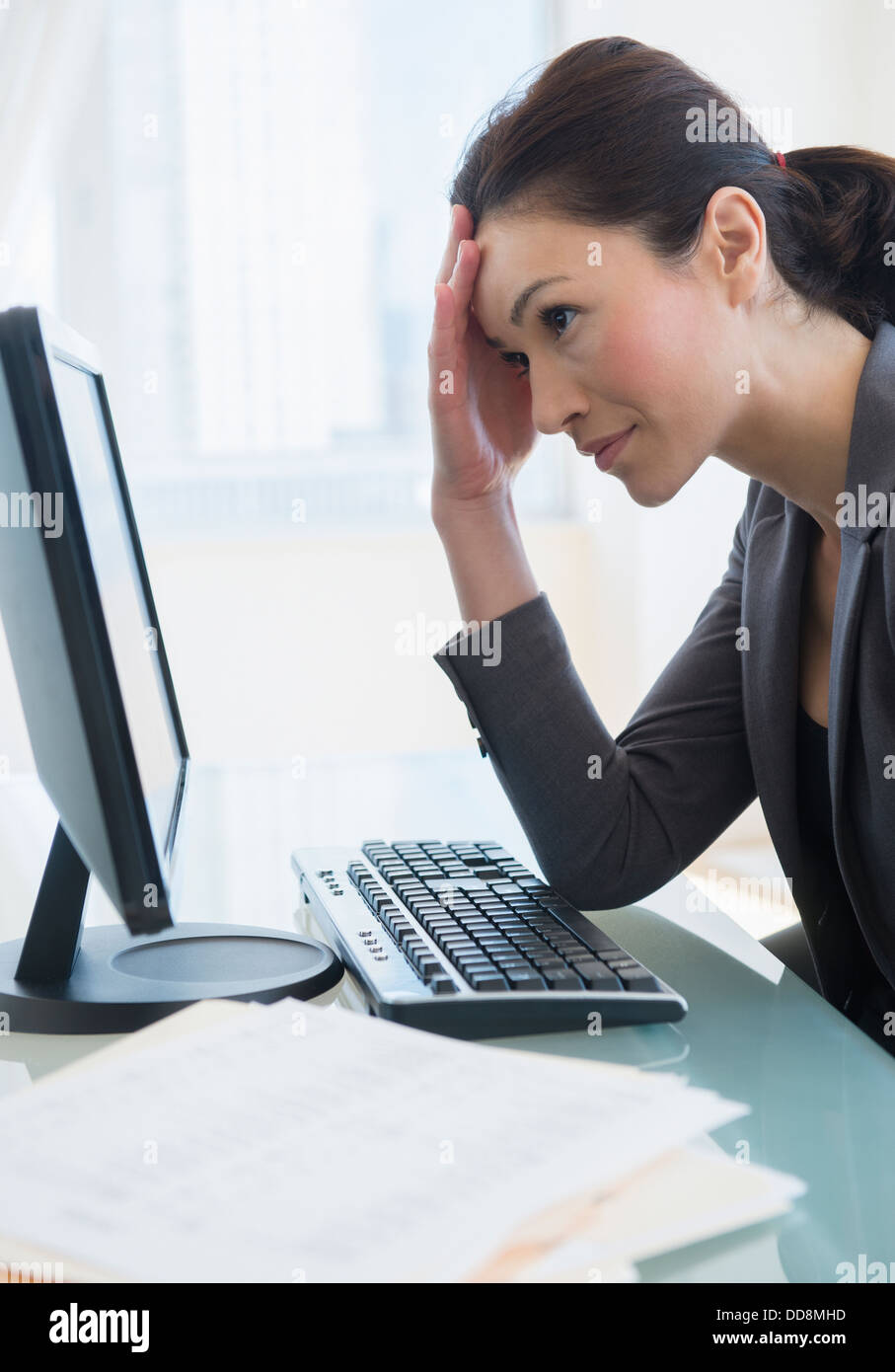 Caucasian businesswoman working at desk Banque D'Images