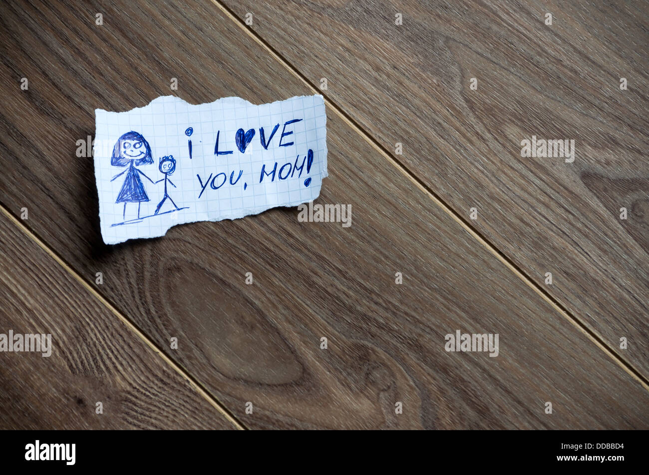 Je t'aime, maman, écrit sur du papier, sur un fond de bois. L'espace pour votre texte. Banque D'Images
