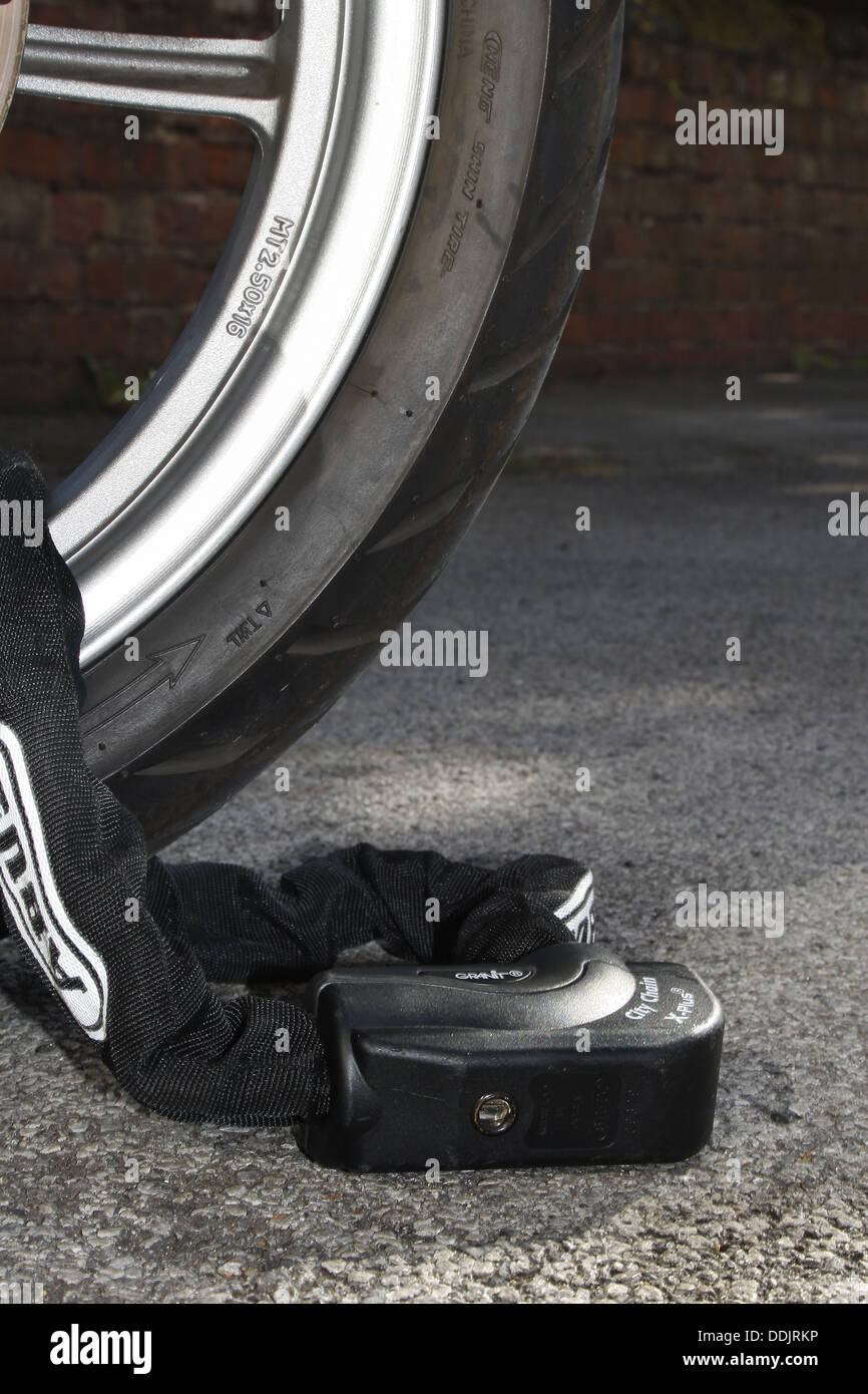 Abus chaîne et verrou de sécurité autour de la roue de scooter Banque D'Images