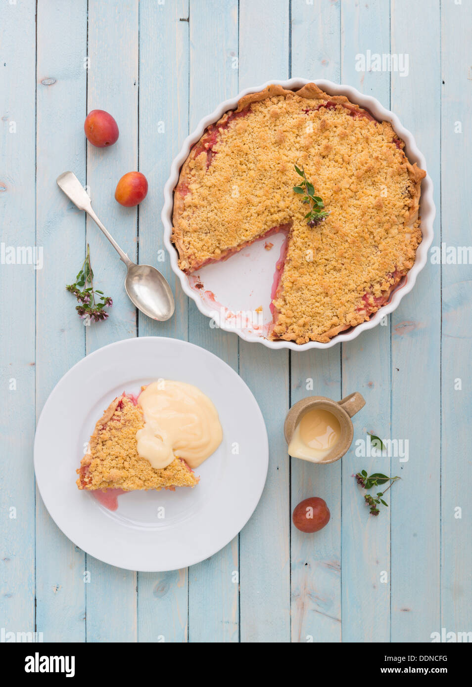 Crumble Tarte aux prunes avec une garniture sur un panneau bleu. Banque D'Images