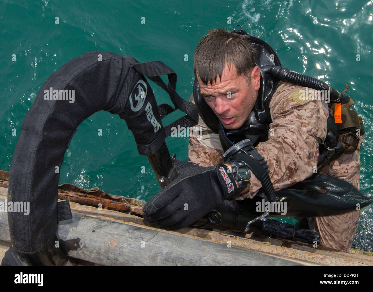 U.S. Marine affecté à un peloton de reconnaissance de la Force maritime, de la Force de Raid, 26e Marine Expeditionary Unit (MEU), monte une échelle qu'il effectue une insertion amphibies sur les infrastructures maritimes, alors que la formation des marines étrangères dans la 5e Flotte des États-Unis sont Banque D'Images