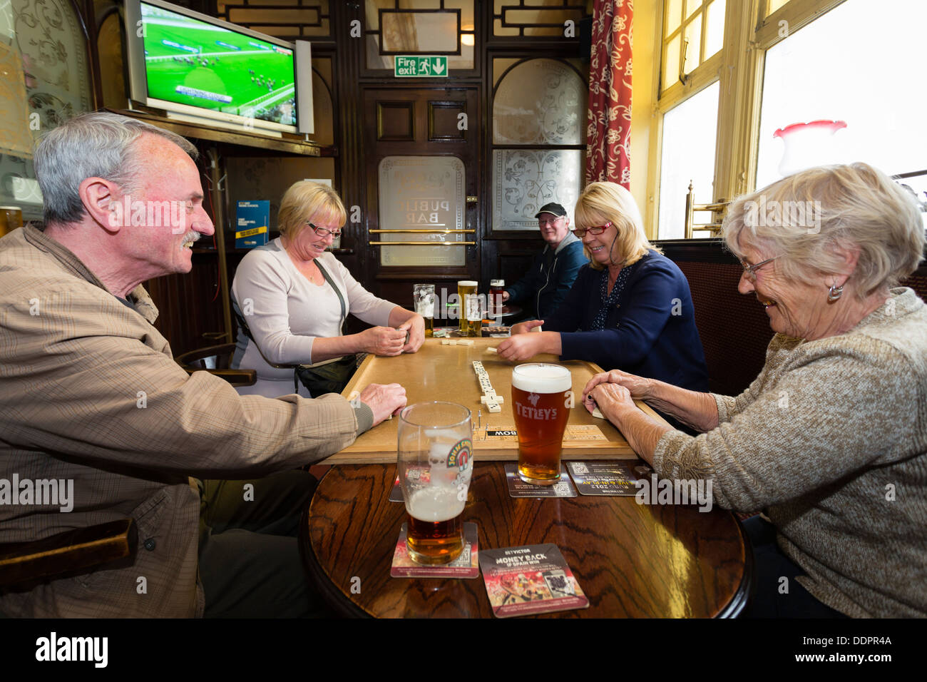 Deux hommes et deux femmes jouant aux dominos dans le pub à Leeds Cardigan Arms Banque D'Images