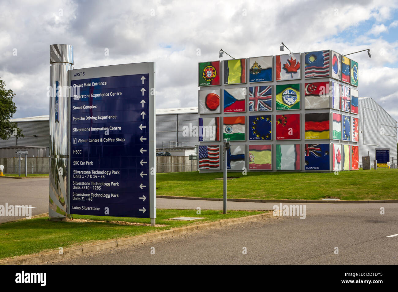 L'entrée du circuit de course de Silverstone avec un monolithe représentant des drapeaux du monde. Banque D'Images