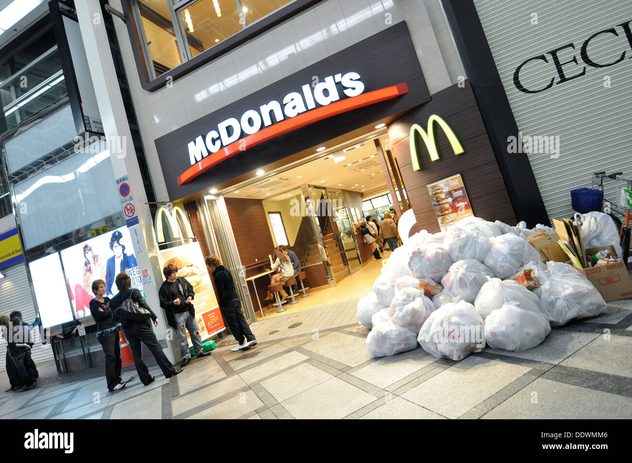 Un McDonald's restaurant fast food avec beaucoup de déchets entassés à l'extérieur. Banque D'Images