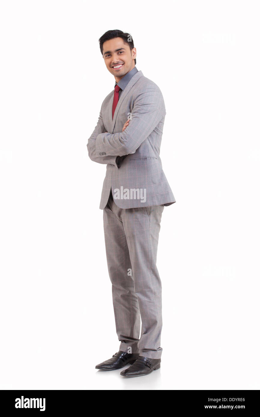 Full Length portrait of happy young man standing against white background Banque D'Images