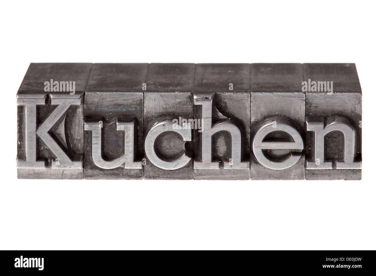 Plomb ancien lettres formant le mot "Kuchen", l'allemand pour cake Banque D'Images
