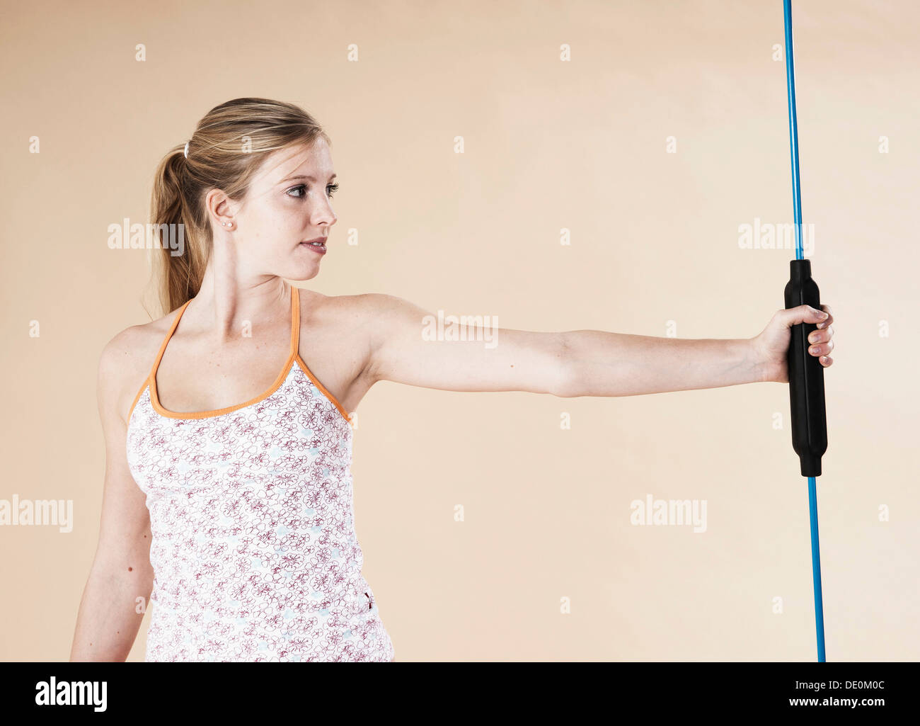 Jeune femme faisant des exercices de sport avec une tige Banque D'Images
