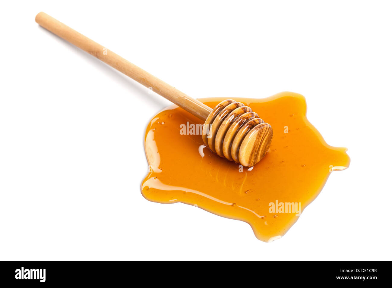 Le miel et le balancier en bois isolé Banque D'Images