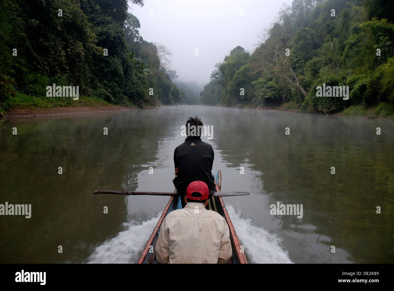 Bateau flottant en bois solitaire en amont sur la rivière Nam Ou, de brume et de jungle sur la rive du fleuve, Ban Phou Den Din, Sopkang Banque D'Images