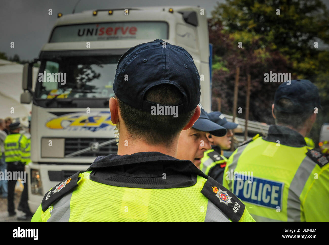 Balcombe, West Sussex, UK . 13e Août, 2013. Des agents de police avaient à marcher plus rapidement aujourd'hui que les manifestants n'entravé la progression de leur escort un autre camion chargé avec des tuyaux, en Cuadrilla entrée du site.. La fracturation anti écologistes protestent contre les forages d'essai par Cuadrilla sur le site de West Sussex qui pourraient mener à la processus de fracturation controversée.avis d'expulsion sous réserve de la décision de la cour sur le lundi a été affiché au camp anti fracturation hydraulique. Crédit : David Burr/Alamy Live News Banque D'Images