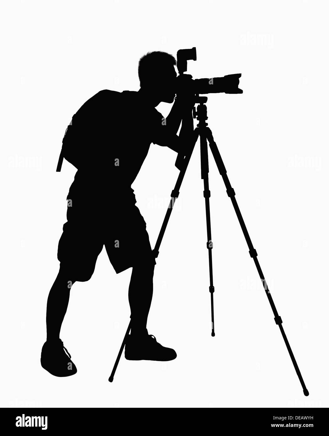 Silhouette of man prendre des photos avec l'appareil photo sur trépied. Banque D'Images