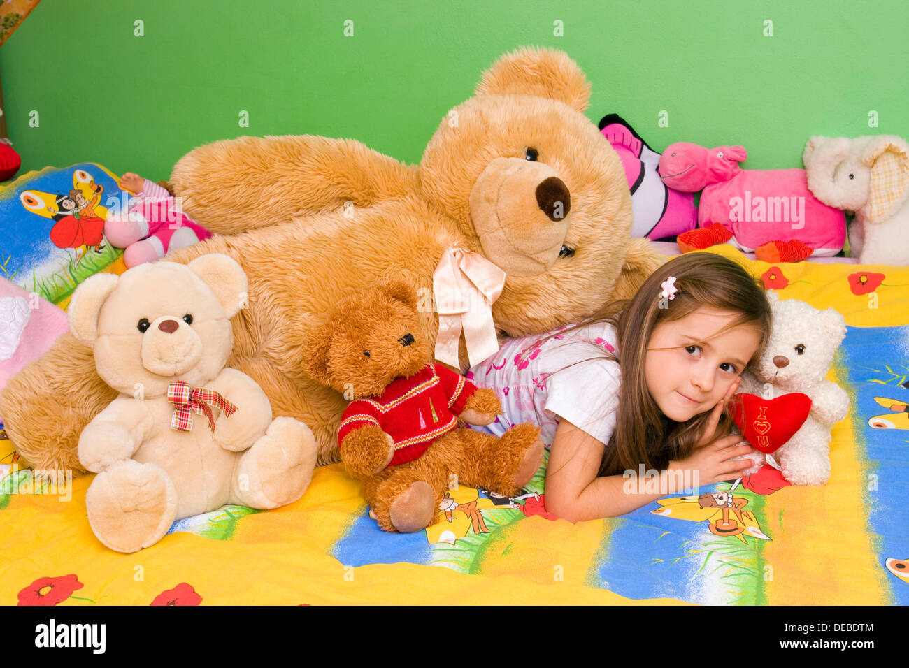 Fille, 4 ans, avec beaucoup de jouets en peluche Banque D'Images