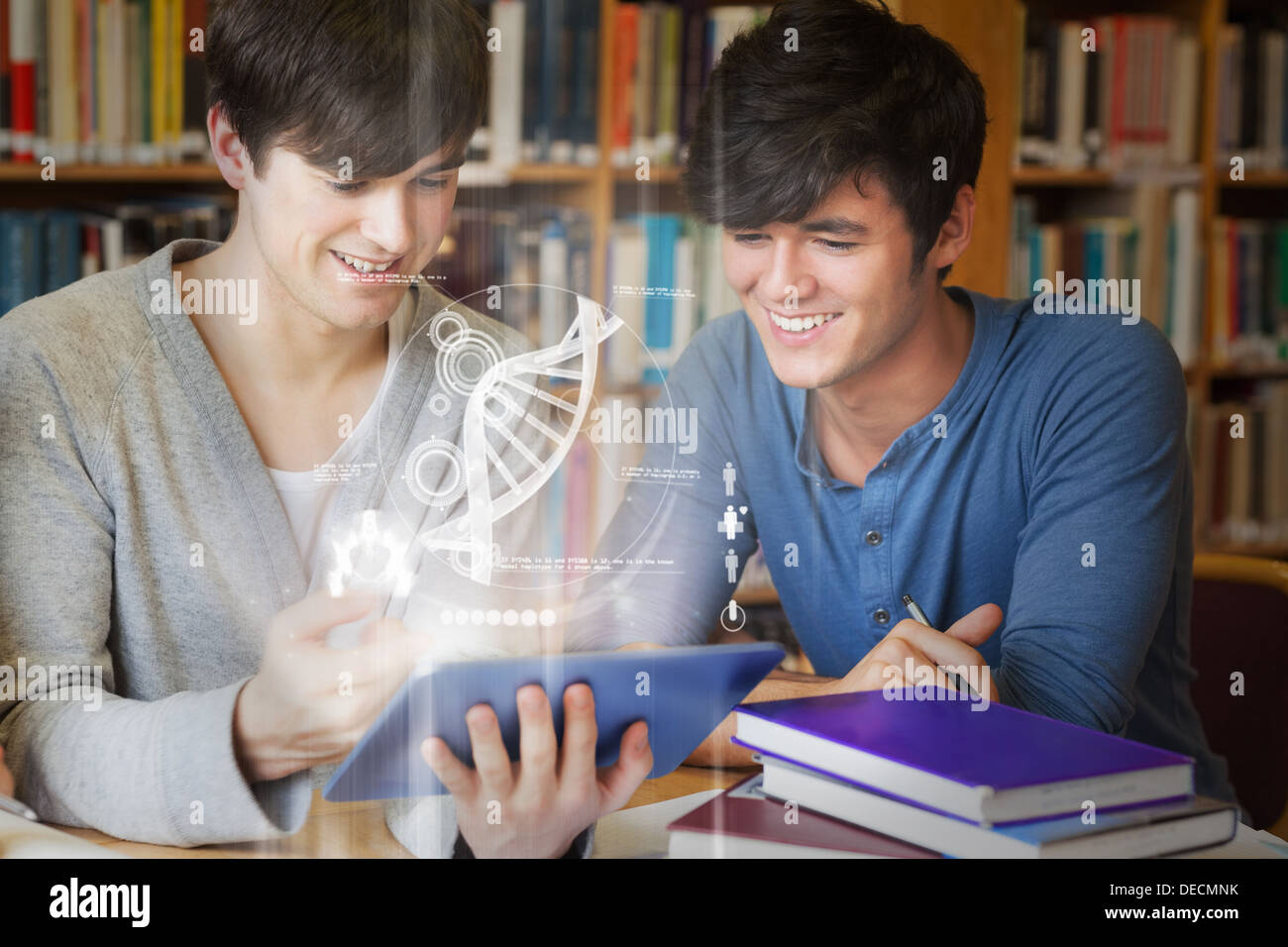 Students using futuristic hologram to learn biology from tablet Banque D'Images