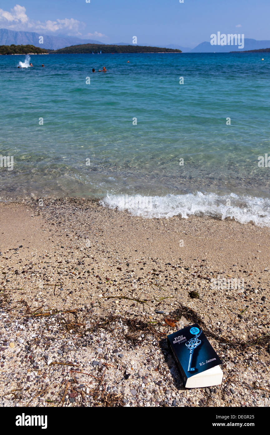 50 50 nuances de grey book libéré sur le sable de la plage Maison de vacances Lefkas Nidri lecture île grecque Grèce Lefkada Nydri Banque D'Images
