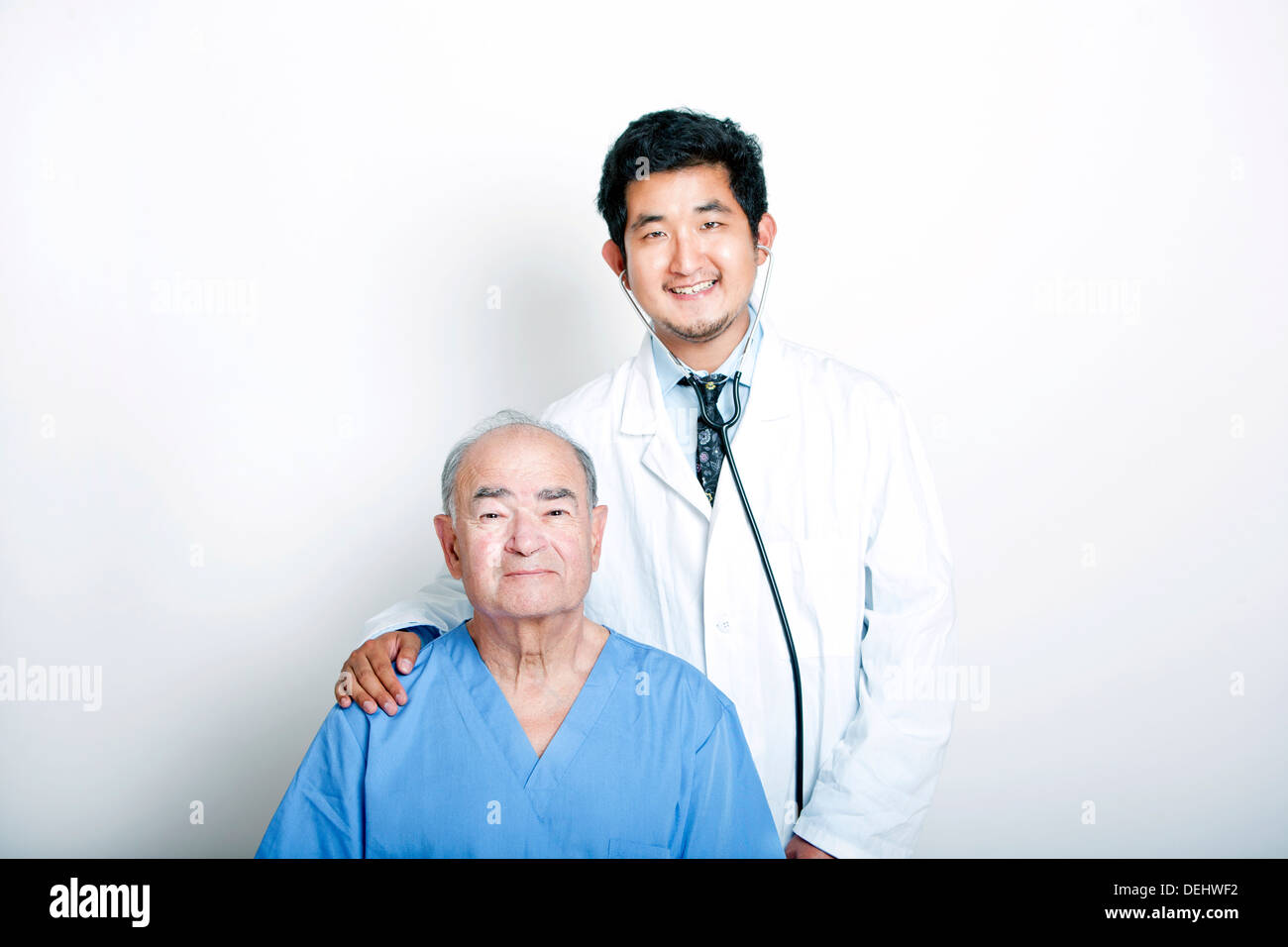 Un jeune médecin asiatique avec sa main sur l'épaule d'un patient adulte Senior Banque D'Images