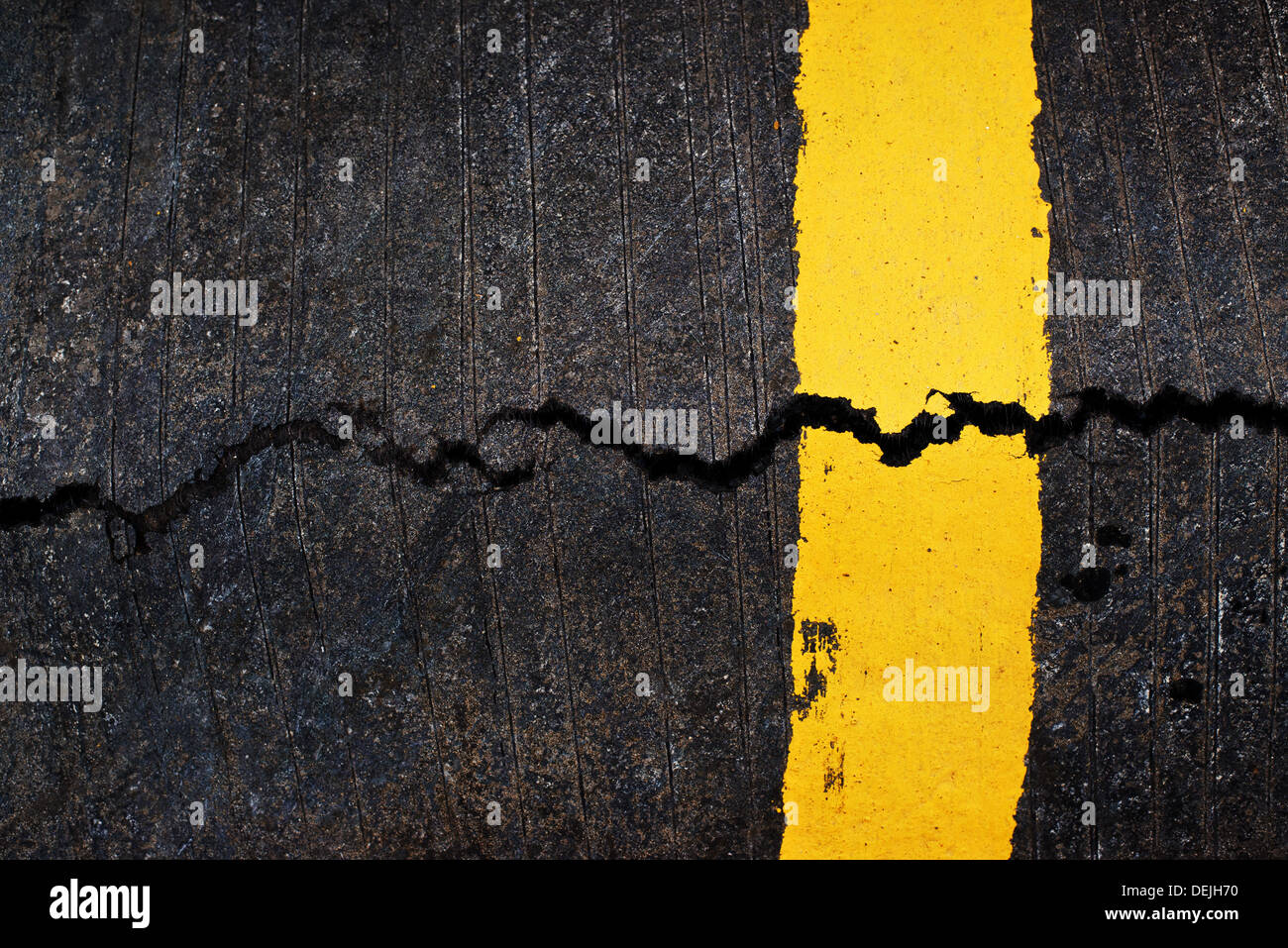 Ligne jaune sur la route d'asphalte fissuré, texture urbaine Banque D'Images