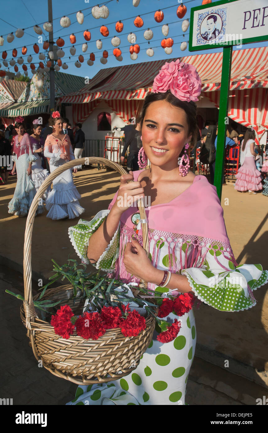 Foire d'avril, jeune femme portant une robe flamenco traditionnel et avec panier de fleurs, Séville, Andalousie, Espagne, Europe Banque D'Images