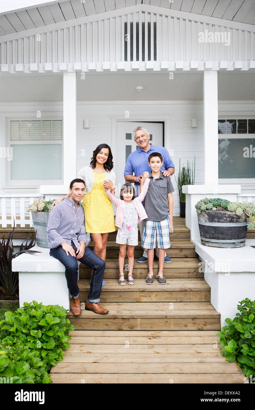 Family smiling together on porch Banque D'Images