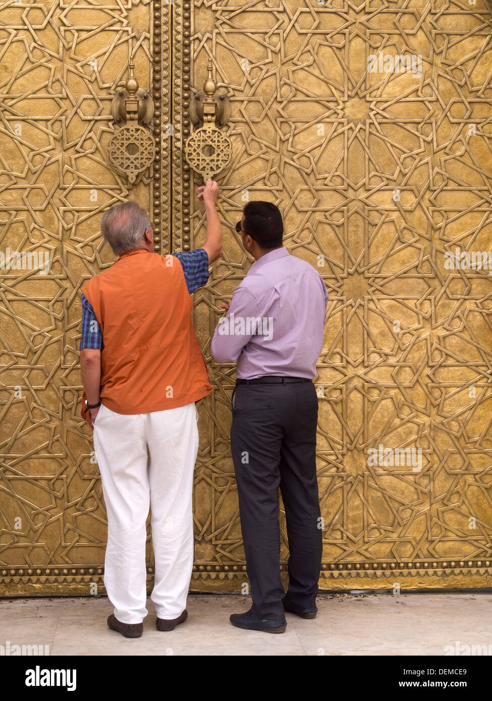 Les gens de toucher les heurtoirs de porte du Dar El Makhzen - Palais Royal, Fès, Maroc Banque D'Images
