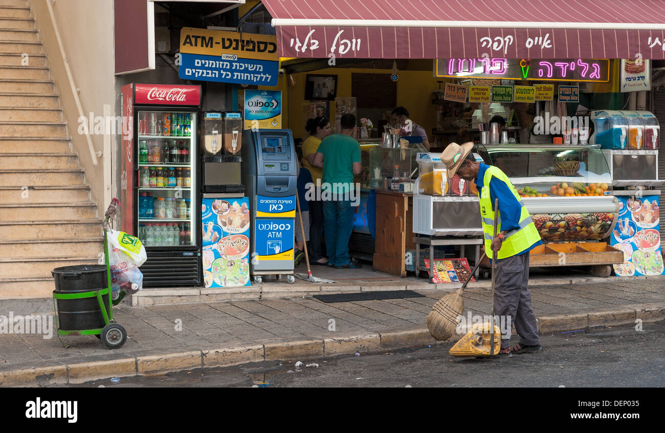Un travailleur de l'assainissement qui balayent la rue dans la vieille ville de Jaffa / Yafo, Israël Banque D'Images